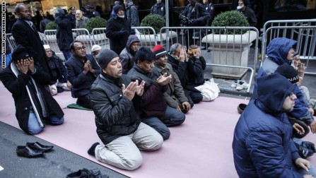 A group of Muslims pray before a rally in front of Trump Tower December 20, 2015 in New York. Republican presidential hopeful Donald Trump proposed a call for a ban on Muslims entering the United States. AFP PHOTO/KENA BETANCUR / AFP / KENA BETANCUR        (Photo credit should read KENA BETANCUR/AFP/Getty Images)