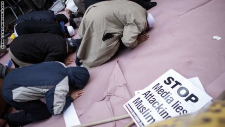 A group of Muslims pray before a rally in front of Trump Tower December 20, 2015 in New York. Republican presidential hopeful Donald Trump proposed a call for a ban on Muslims entering the United States. AFP PHOTO/KENA BETANCUR / AFP / KENA BETANCUR        (Photo credit should read KENA BETANCUR/AFP/Getty Images)